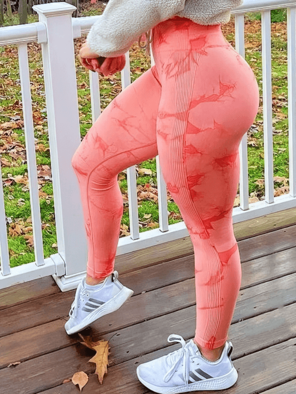 Seamless Tight Women's Leggings with PushUp Effect in coral, showcasing high waist design on outdoor deck. Perfect fit for casual look.